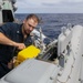 Sailors aboard USS Shoup inspect torpedo tubes