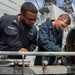 Sailors aboard USS Shoup inspect torpedo tubes