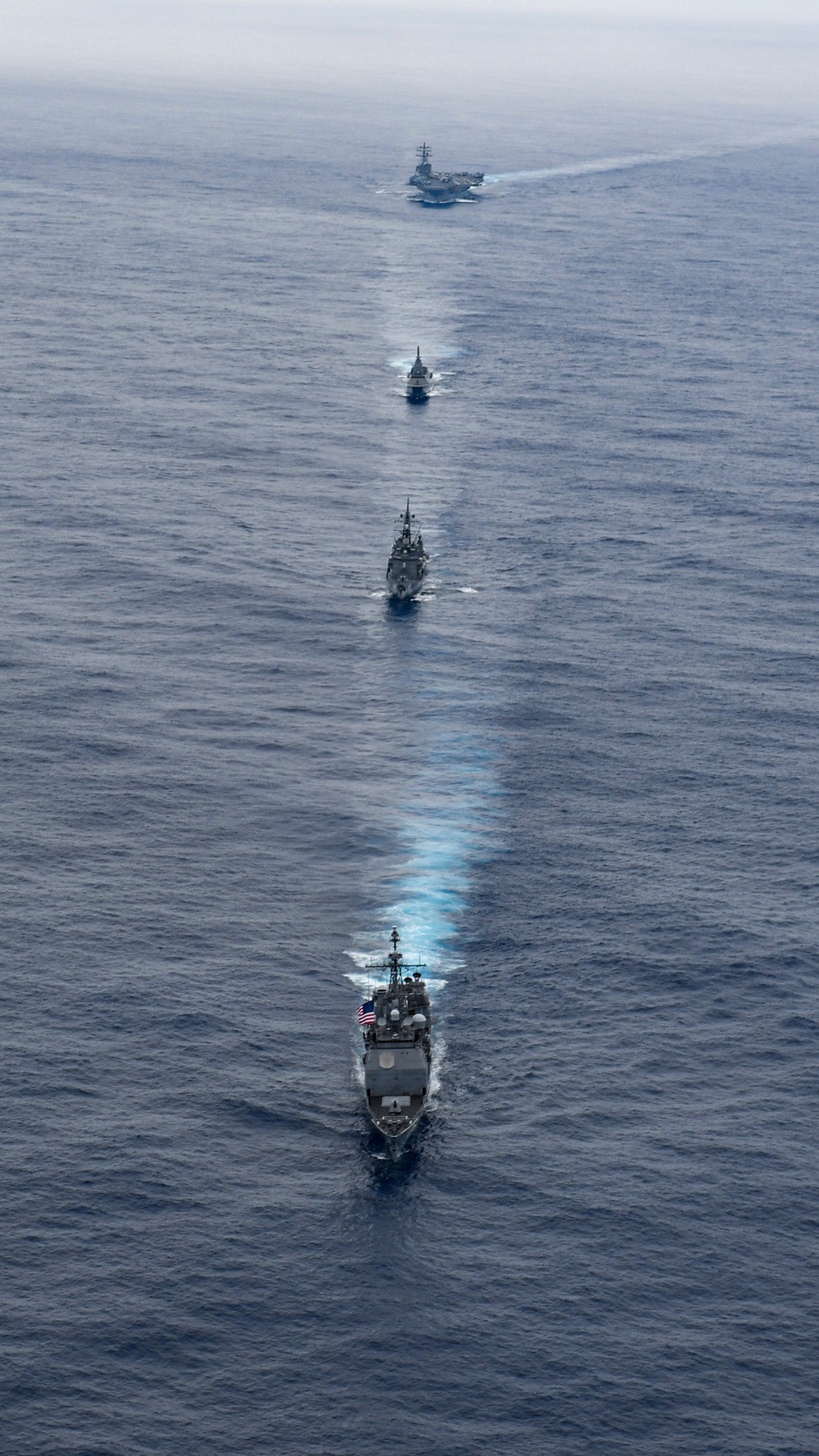 USS Ronald Reagan (CVN 76) steams in formation with guided-missile cruiser USS Antietam (CG 54), JMSDF destroyer JS Yuudachi (DD 103) and JMSDF frigate JS Noshiro (FFM 3)