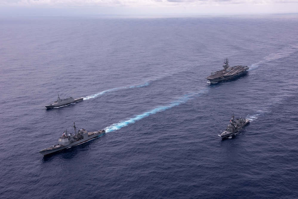 USS Ronald Reagan (CVN 76) steams in formation with guided-missile cruiser USS Antietam (CG 54), JMSDF destroyer JS Yuudachi (DD 103) and JMSDF frigate JS Noshiro (FFM 3)