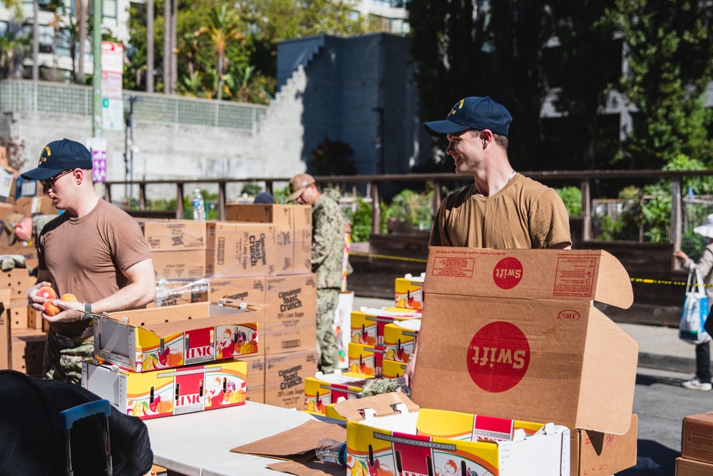 U.S. Navy Sailors distribute food to the local community during San Francisco Fleet Week