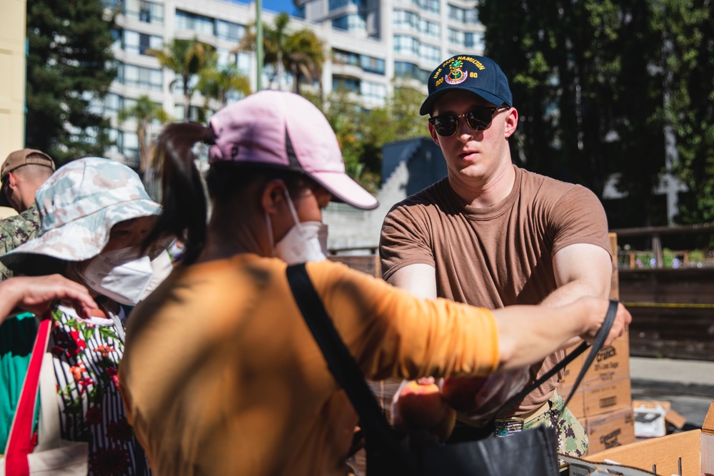 U.S. Navy Sailors distribute food to the local community during San Francisco Fleet Week