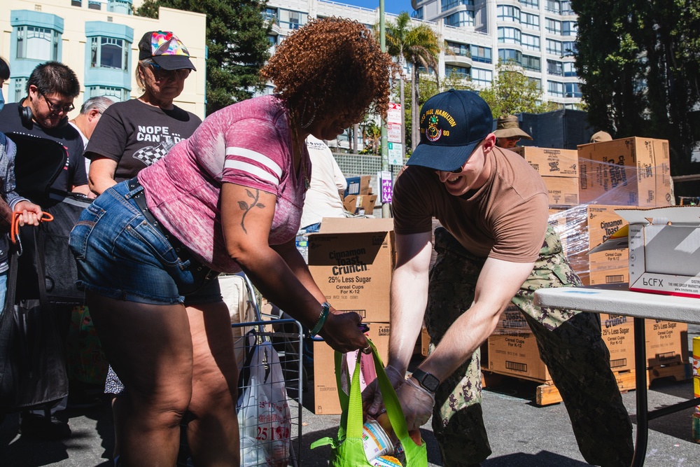 U.S. Navy Sailors distribute food to the local community during San Francisco Fleet Week