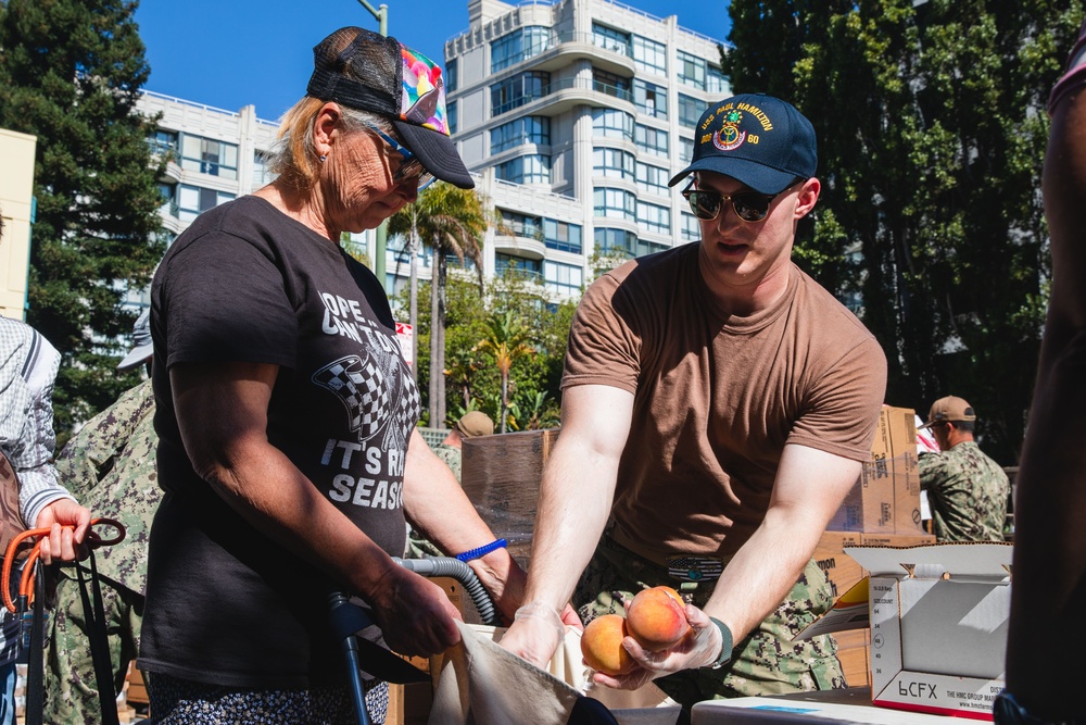 U.S. Navy Sailors distribute food to the local community during San Francisco Fleet Week