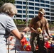 U.S. Navy Sailors distribute food to the local community during San Francisco Fleet Week