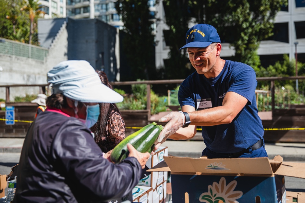 U.S. Coast Guardsman distribute food to the local community during San Francisco Fleet Week