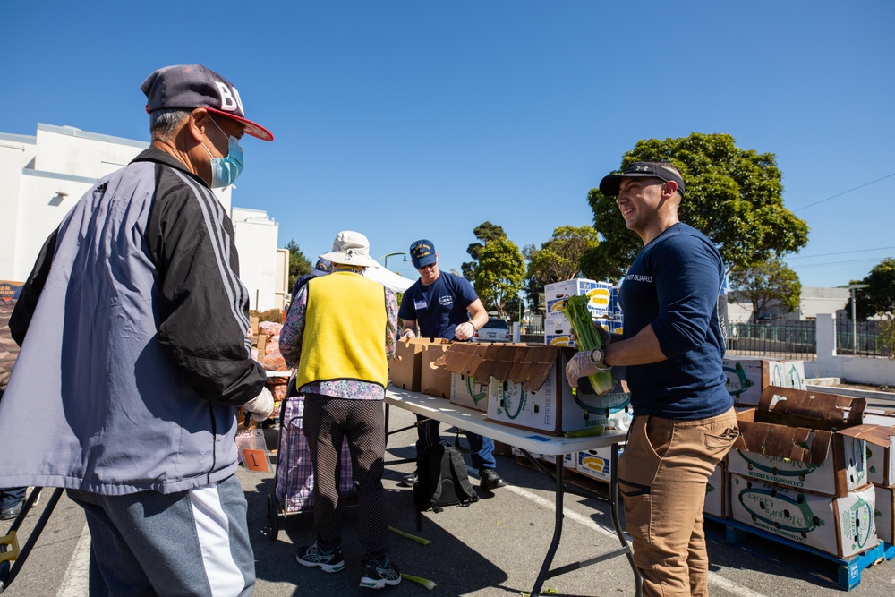 U.S. Coast Guardsmen distribute food to the local community during San Francisco Fleet Week 23