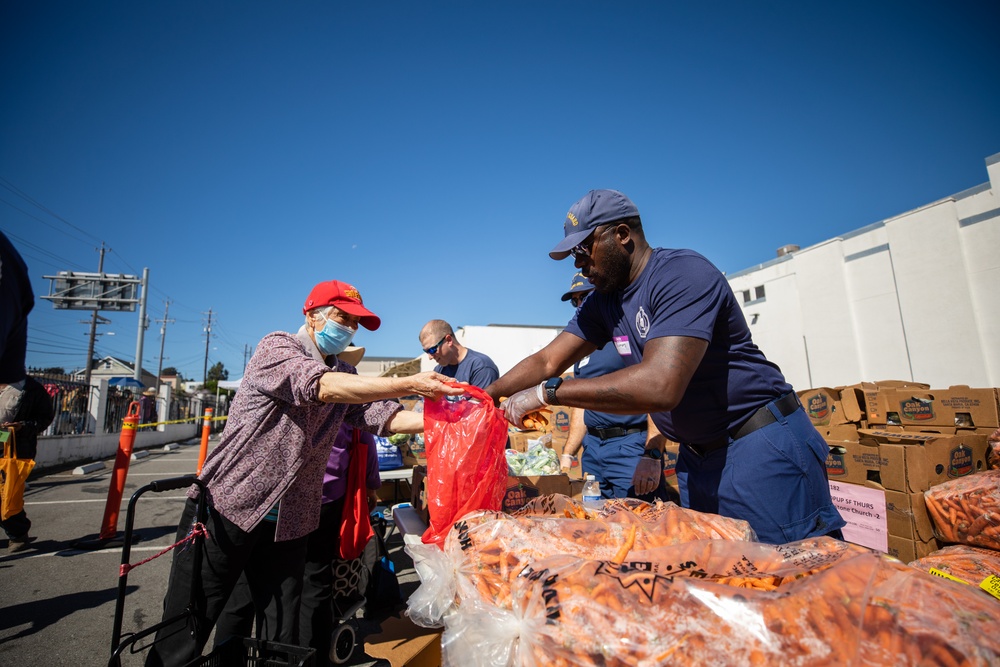 U.S. Coast Guardsmen distribute food to the local community during San Francisco Fleet Week 23