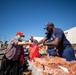 U.S. Coast Guardsmen distribute food to the local community during San Francisco Fleet Week 23