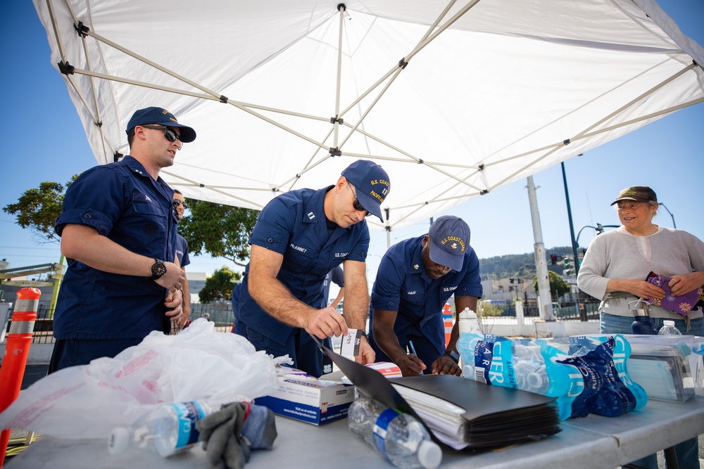 U.S. Coast Guardsmen distribute food to the local community during San Francisco Fleet Week 23