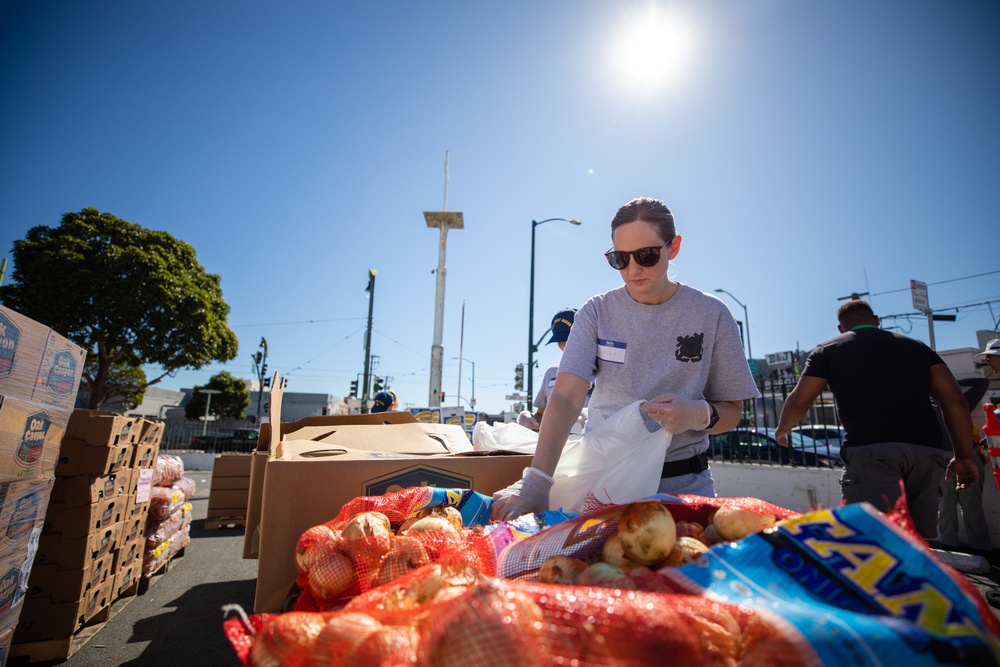 U.S. Coast Guardsmen distribute food to the local community during San Francisco Fleet Week 23