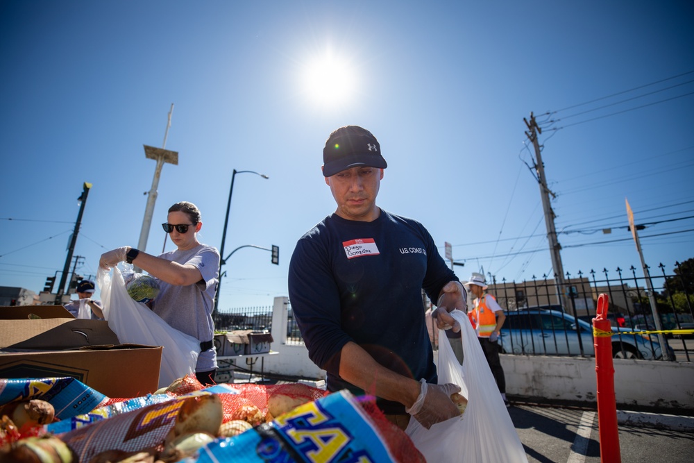 U.S. Coast Guardsmen distribute food to the local community during San Francisco Fleet Week 23