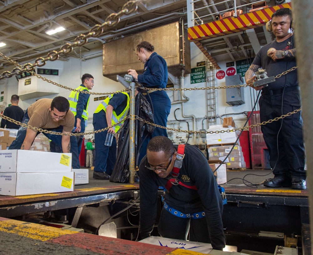 USS Ronald Reagan (CVN 76) conducts vertical replenishment with USNS Charles Drew (T-AKE 10)