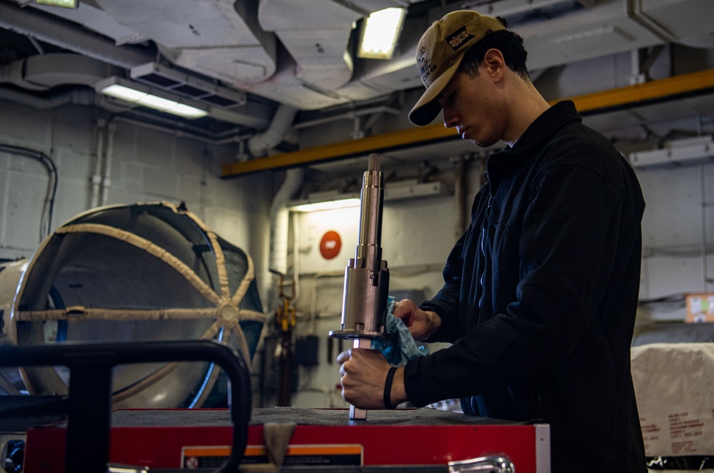 Sailor Inspects A Locking Bolt