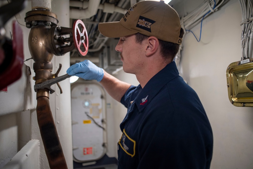 U.S. Navy Sailor Loosens Firehose