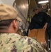 Sailors Transport Cargo Down Ladderwell