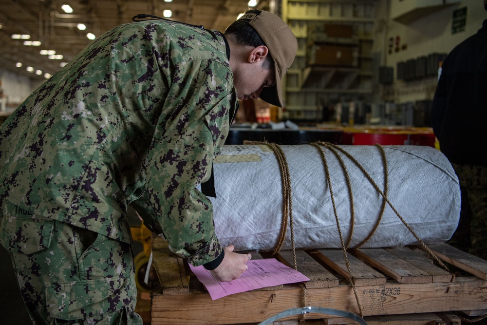 U.S. Navy Sailor Offloads Material