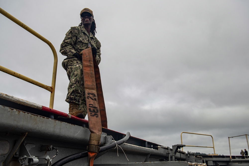 U.S. Navy Sailor Stores Fire Hose