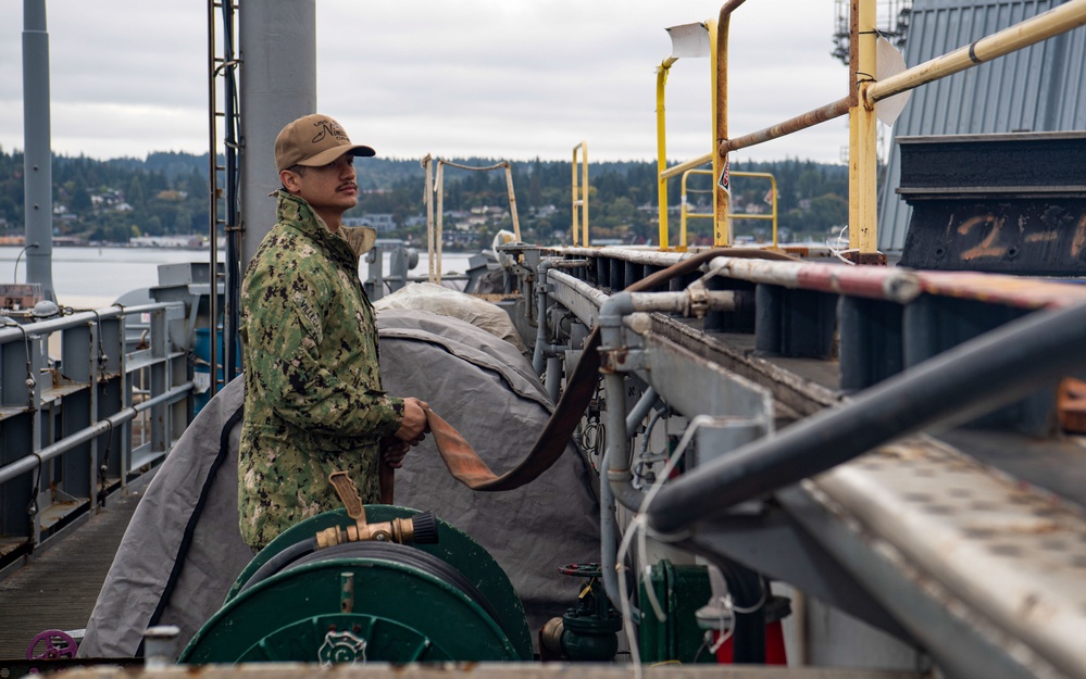 U.S. Navy Sailor Stores Fire Hose