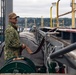 U.S. Navy Sailor Stores Fire Hose