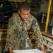 Sailor Loads Cargo Onto Conveyer