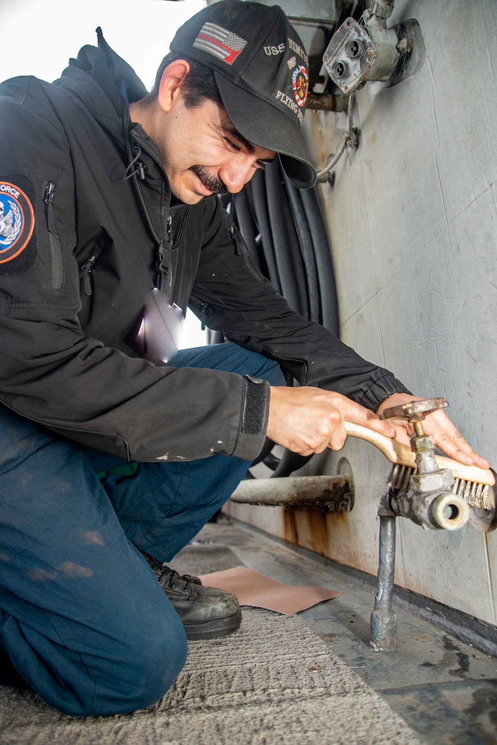 Sailor Removes Paint From Pipe