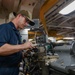 U.S. Navy Sailor Makes Adjustments To A Lathe