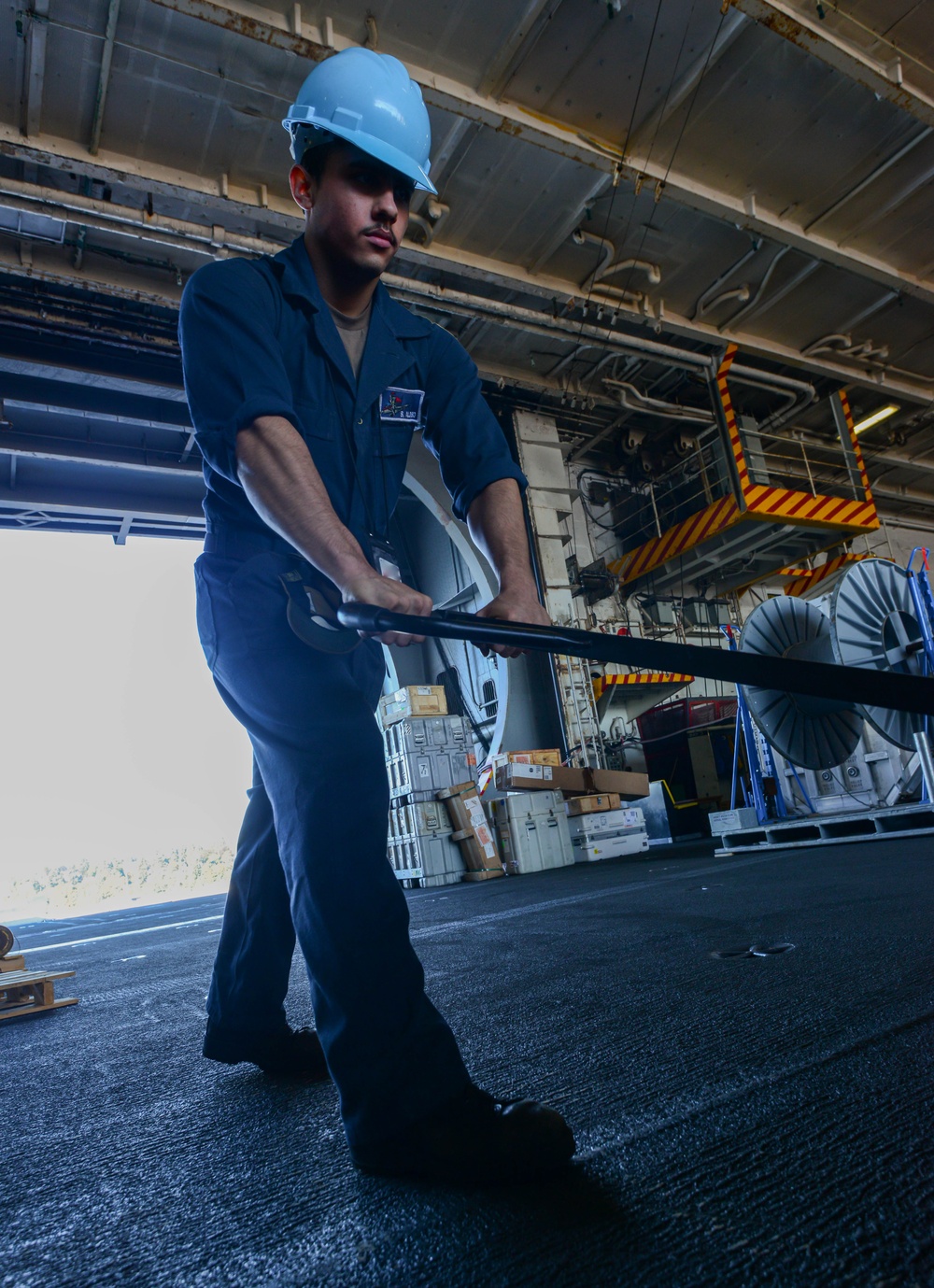 U.S. Navy Sailor Moves Parts For An Offload