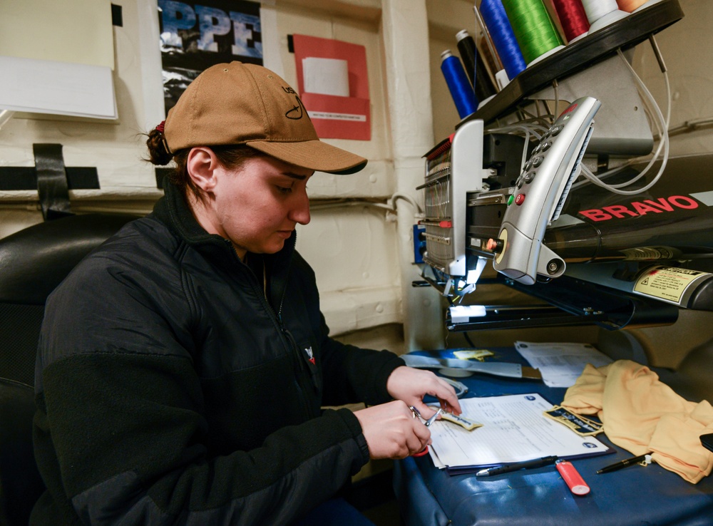 U.S. Navy Sailor Creates Name Tags