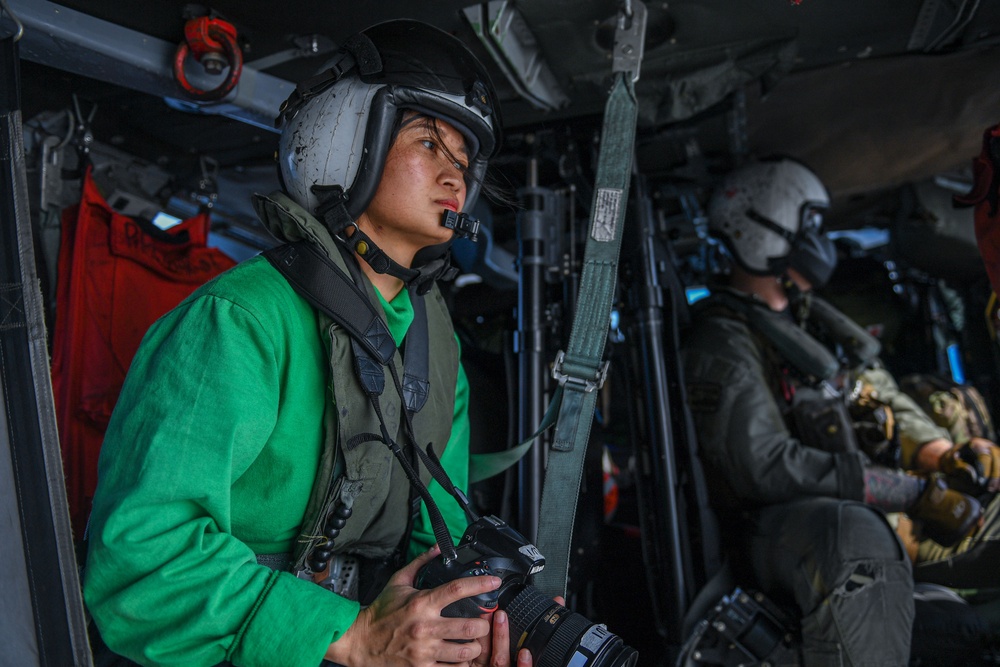 USS Ronald Reagan (CVN 76) and Helicopter Sea Combat Squadron (HSC) 12 Sailors participate in a routine flight