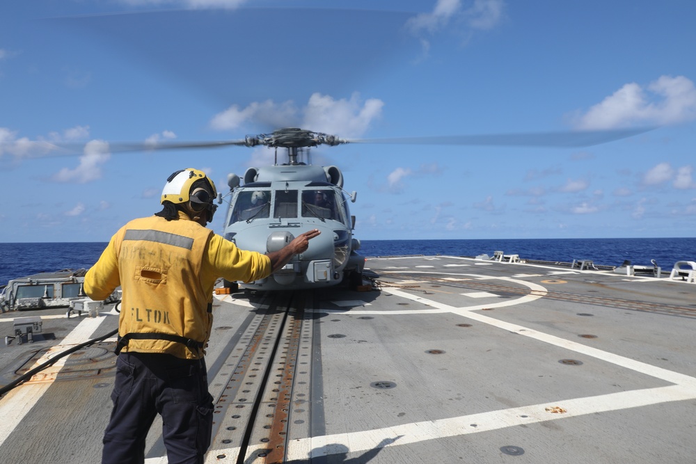 Sailors assigned to the Arleigh Burke-class guided-missile destroyer USS Rafael Peralta (DDG 115) conduct flight quarters in the Philippine Sea