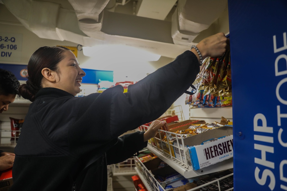 Retail Services Specialists restock the ship’s store aboard the Arleigh Burke-class guided-missile destroyer USS Rafael Peralta (DDG 115) in the Philippine Sea