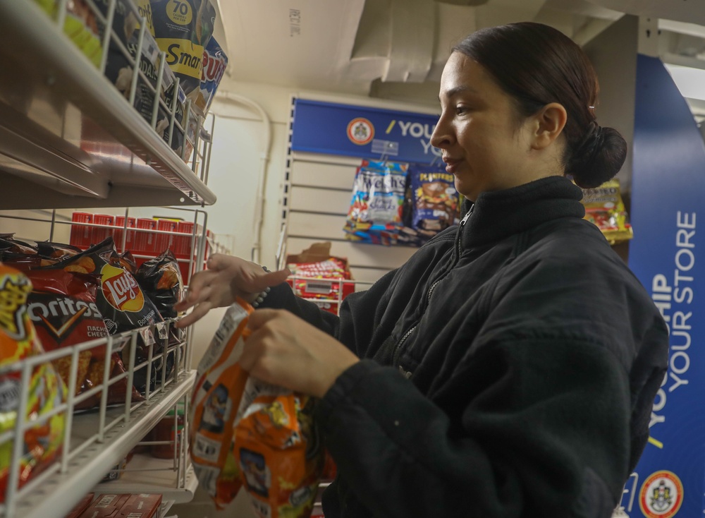 Retail Services Specialists restock the ship’s store aboard the Arleigh Burke-class guided-missile destroyer USS Rafael Peralta (DDG 115) in the Philippine Sea