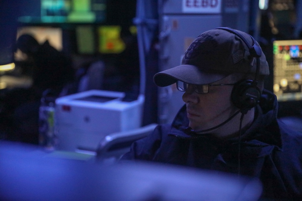 Sailors perform daily operations in the combat information center aboard the Arleigh Burke-class guided-missile destroyer USS Rafael Peralta (DDG 115) in the South China Sea