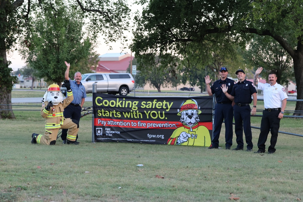 Sparky, firefighters wave to motorists to build awareness