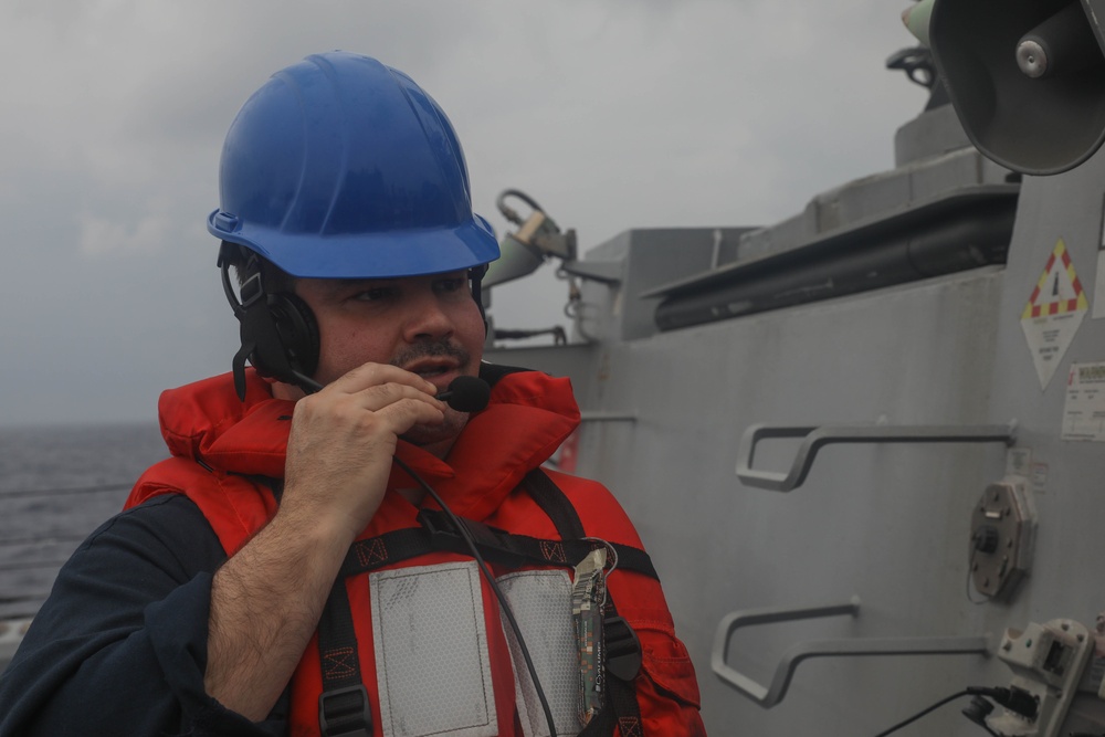 Sailors aboard the USS Rafael Peralta (DDG 115) conducts a replenishment-at-sea with Royal Canadian Navy supply ship MV Asterix in the South China Sea