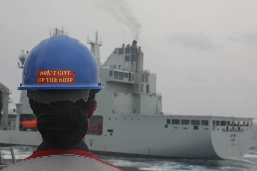 Sailors aboard the USS Rafael Peralta (DDG 115) conducts a replenishment-at-sea with Royal Canadian Navy supply ship MV Asterix in the South China Sea