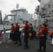 Sailors aboard the USS Rafael Peralta (DDG 115) conducts a replenishment-at-sea with Royal Canadian Navy supply ship MV Asterix in the South China Sea