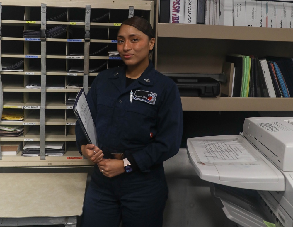 Personnel Specialist 2nd Class Noryko Borja, from Elizabeth, New Jersey, poses for a picture in the administration's office aboard the USS Rafael Peralta (DDG 115) in the South China Sea