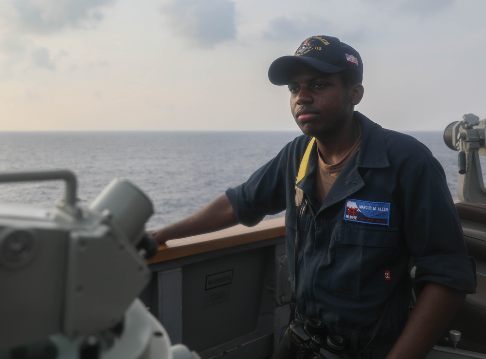 Sailors stand watch on the bridge aboard the USS Rafael Peralta (DDG 115) in the South China Sea