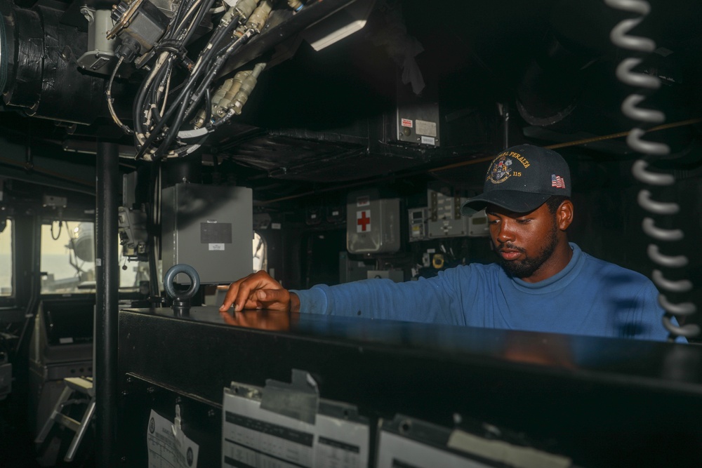 Boatswain’s Mate Seaman Tywane Davis steers the USS Rafael Peralta (DDG 115) in the South China Sea