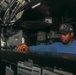 Boatswain’s Mate Seaman Tywane Davis steers the USS Rafael Peralta (DDG 115) in the South China Sea