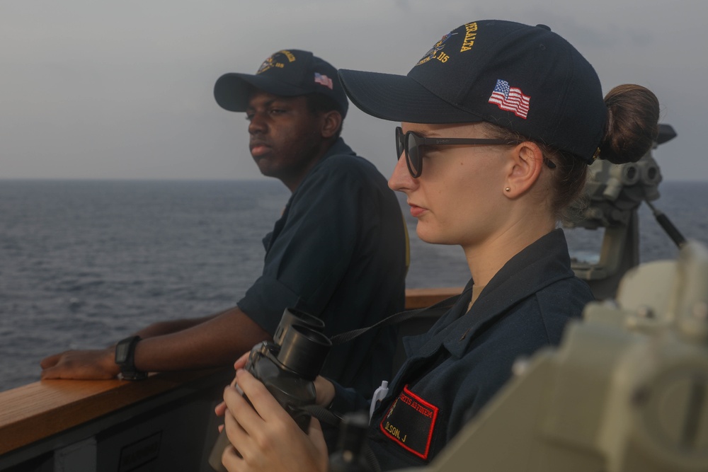 Sailors perform digital fluxgate magnetic compass (DFGMC) calibrations on the bridge aboard the USS Rafael Peralta (DDG 115) in the South China Sea