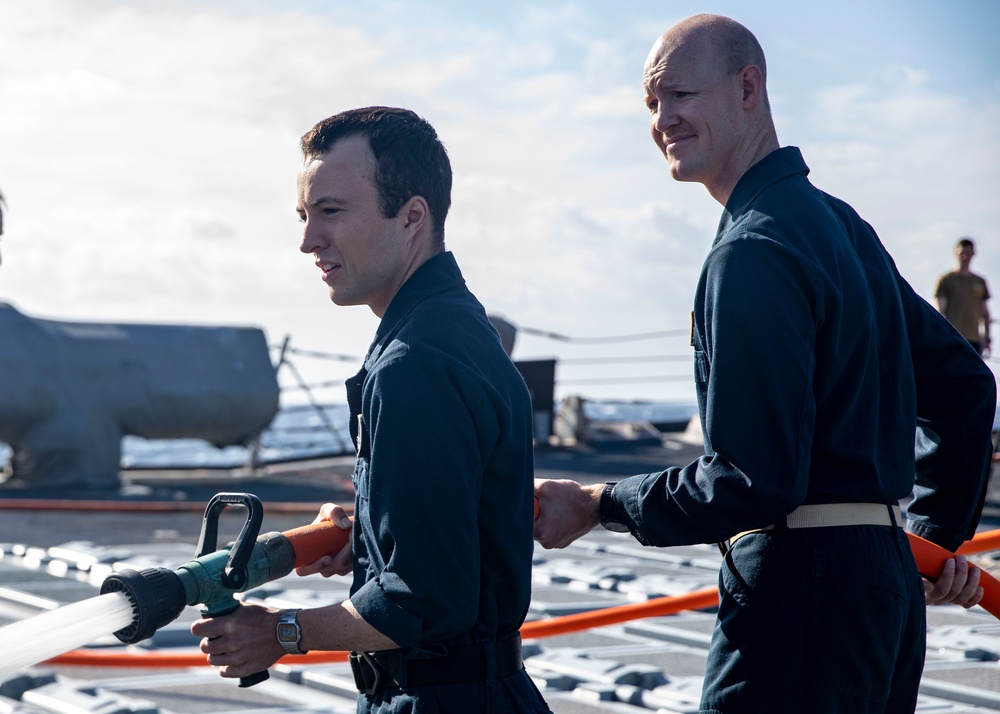 Sailors Conduct a Fresh-Water Wash Down Aboard USS John Finn (DDG 113)