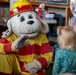 Sparky the Fire Dog Reads to Children at Fairchild Library