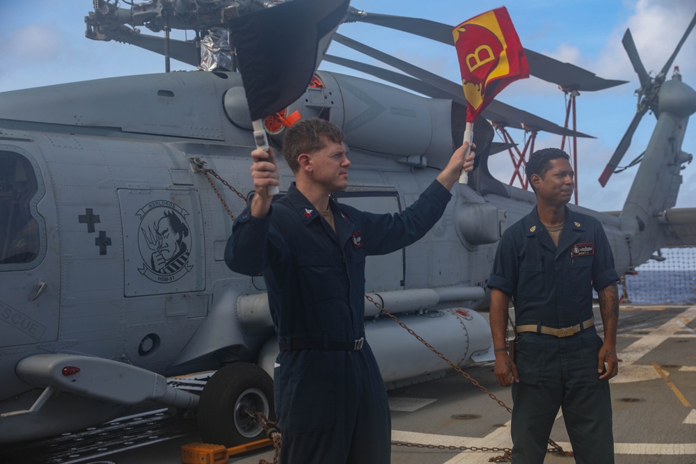 Sailors aboard the USS Rafael Peralta (DDG 115) conduct a crash and salvage drill