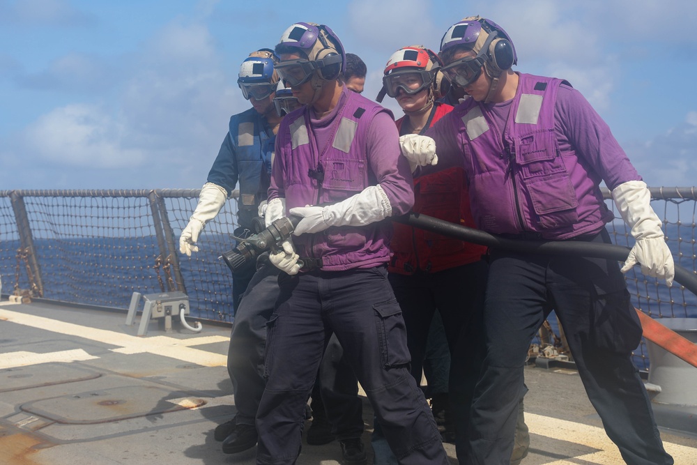 Sailors aboard the USS Rafael Peralta (DDG 115) conduct a crash and salvage drill