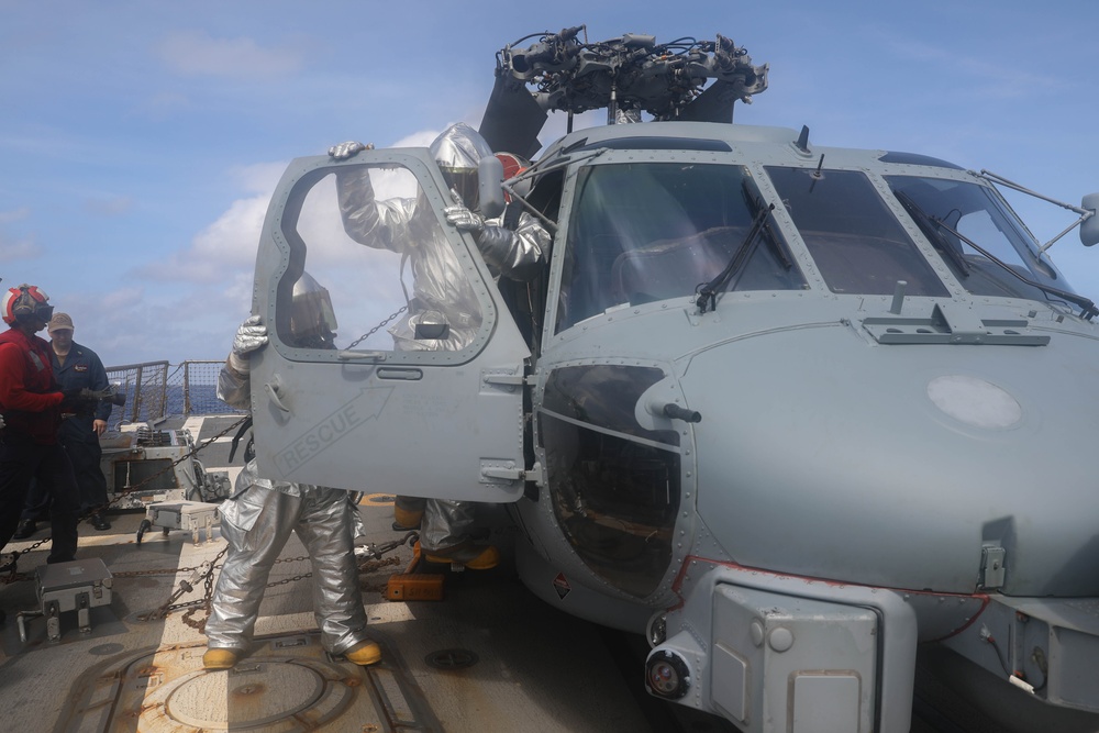 Sailors aboard the USS Rafael Peralta (DDG 115) conduct a crash and salvage drill