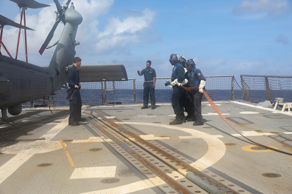 Sailors aboard the USS Rafael Peralta (DDG 115) conduct a crash and salvage drill