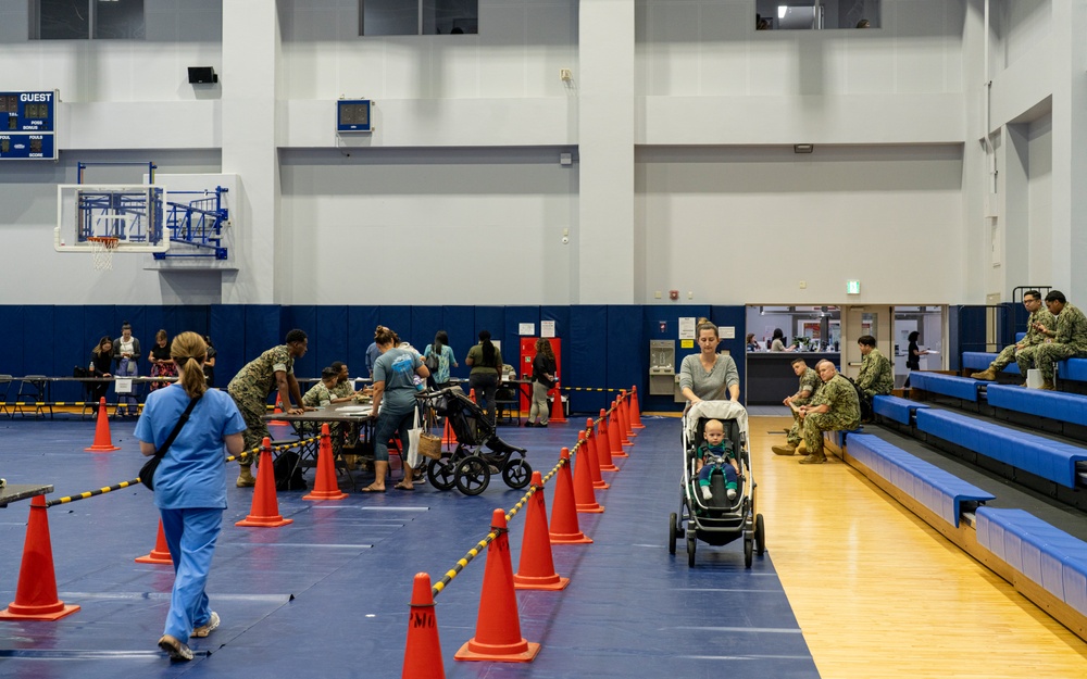 Service members and residents participate in an Emergency Evacuation Program exercise